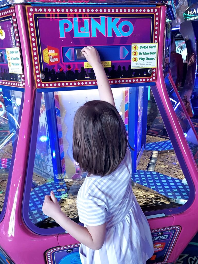 girl playing planko at an arcade