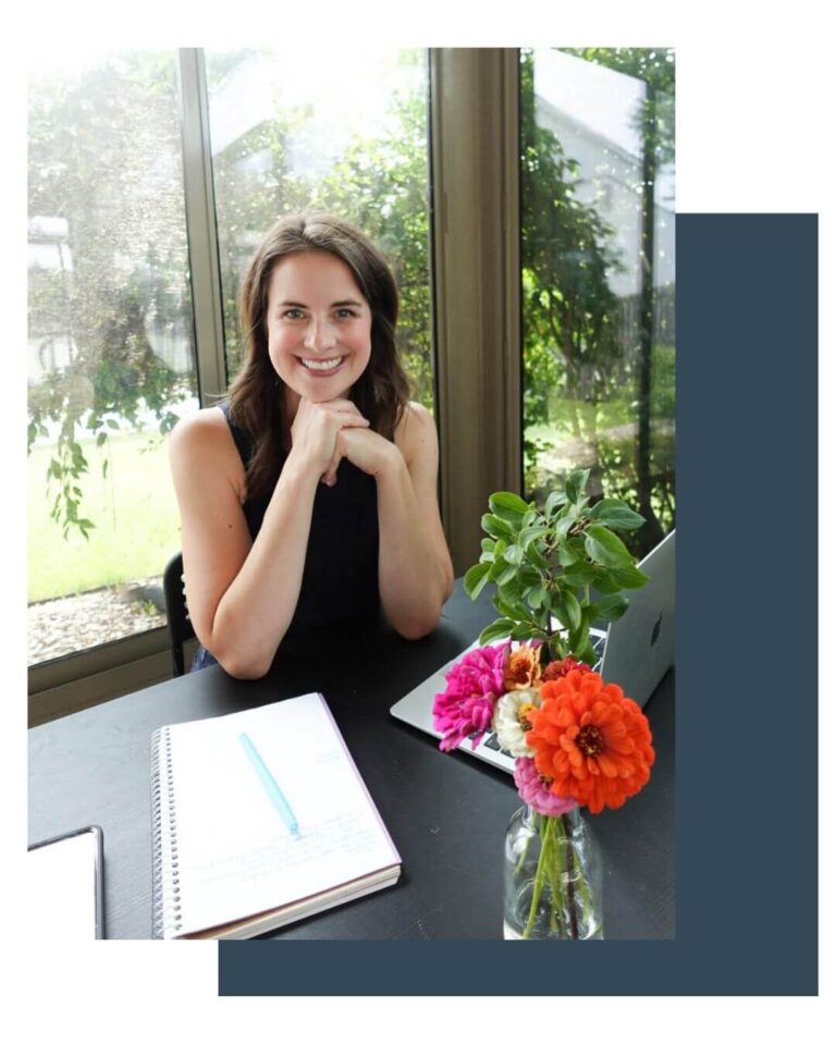 Professional organizer working from a bright home office with a laptop, notebook, and colorful fresh flowers in a vase, offering organizing services in Canton, MI.