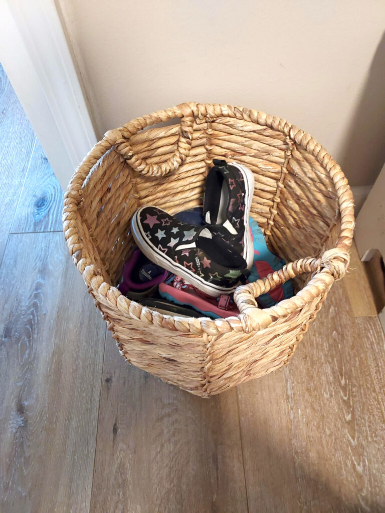 photo of kids' shoes in basket for entryway organization